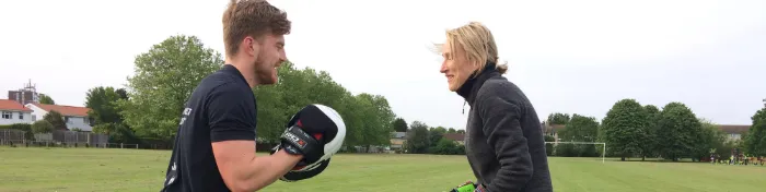 Boxing pad work in a park